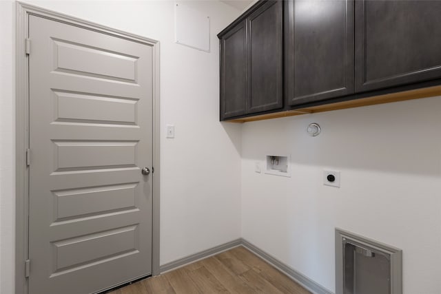 laundry room featuring hookup for a washing machine, cabinets, hookup for an electric dryer, and light hardwood / wood-style floors