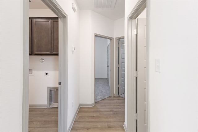 hallway with light hardwood / wood-style flooring