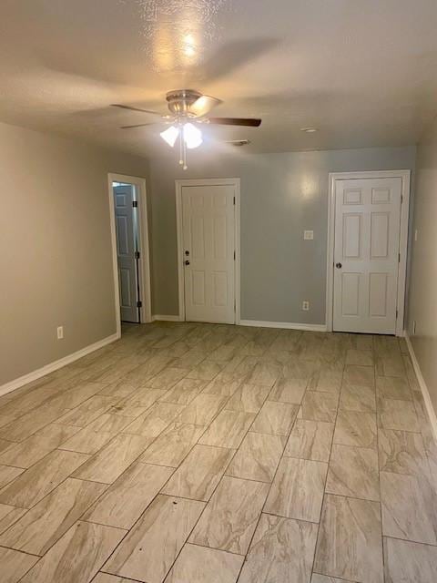 unfurnished room featuring ceiling fan and a textured ceiling