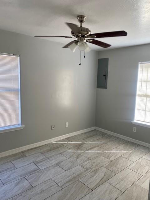 empty room featuring electric panel and ceiling fan