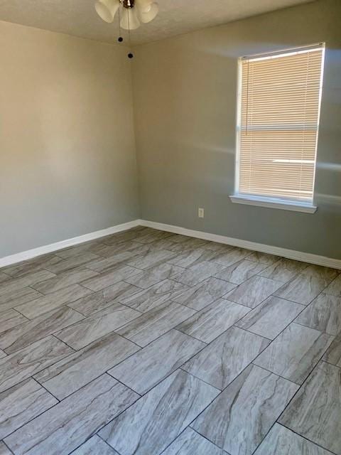 empty room featuring ceiling fan