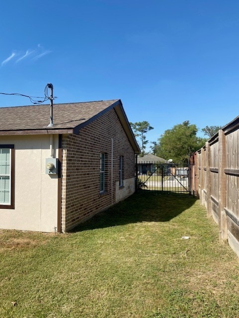 view of side of home featuring a yard