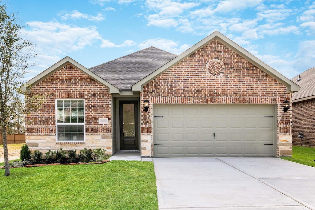 view of front of property featuring a garage and a front lawn