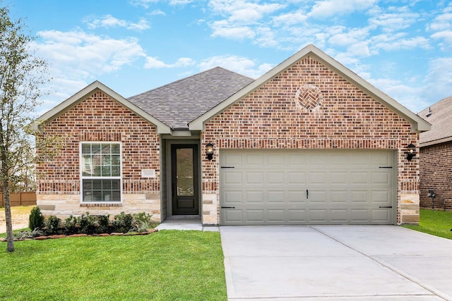 view of front of property featuring a garage and a front lawn