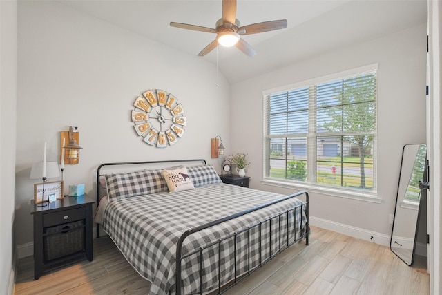 bedroom featuring light hardwood / wood-style floors, ceiling fan, and lofted ceiling