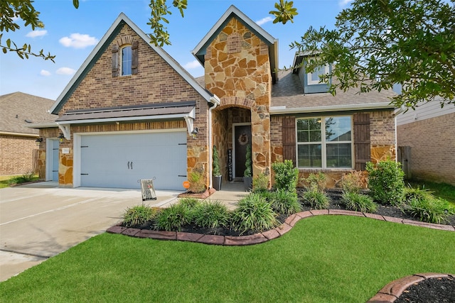 view of front of home featuring a garage and a front lawn