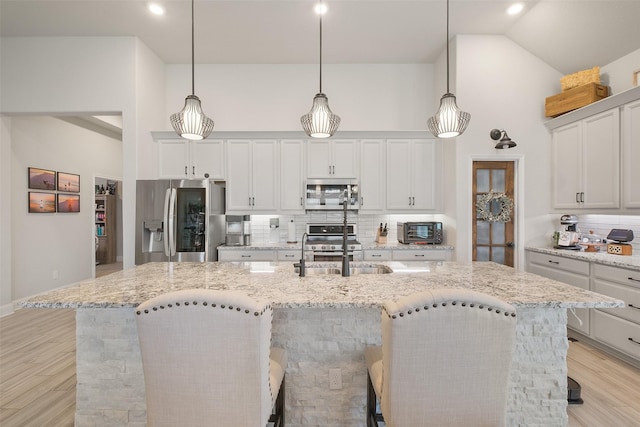 kitchen featuring decorative backsplash, a breakfast bar, and stainless steel appliances