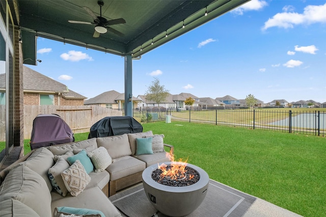 view of patio / terrace with ceiling fan, a grill, a water view, and an outdoor living space with a fire pit