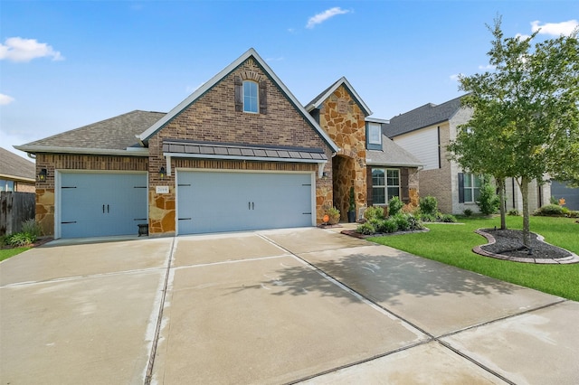 view of front facade with a front yard and a garage