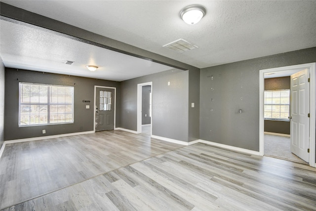 interior space featuring light hardwood / wood-style floors and a textured ceiling