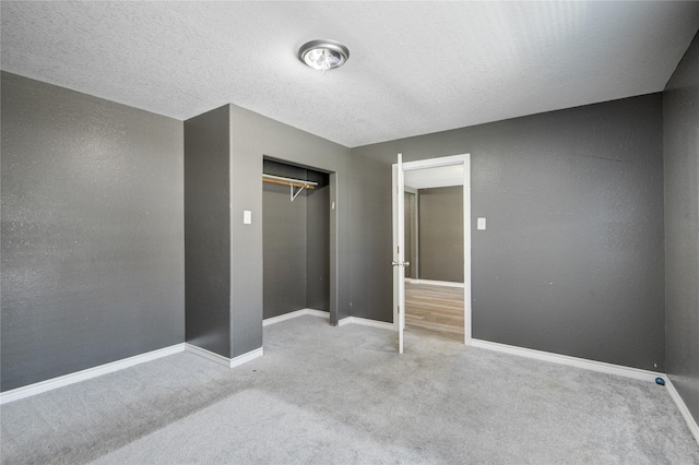 carpeted bedroom with a textured ceiling and a closet