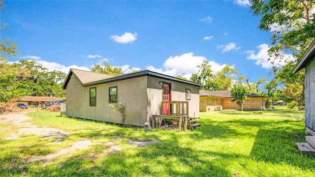 rear view of property with a lawn