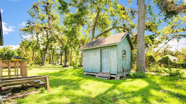 view of outbuilding with a lawn