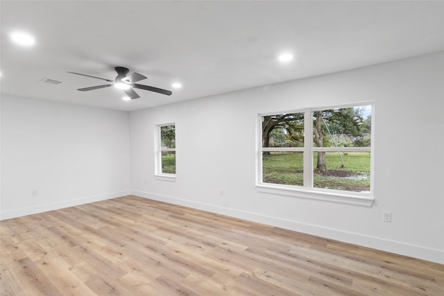 empty room with ceiling fan and light wood-type flooring