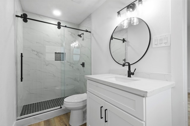 bathroom with vanity, toilet, wood-type flooring, and walk in shower