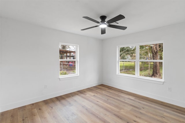 spare room with light hardwood / wood-style floors, plenty of natural light, and ceiling fan