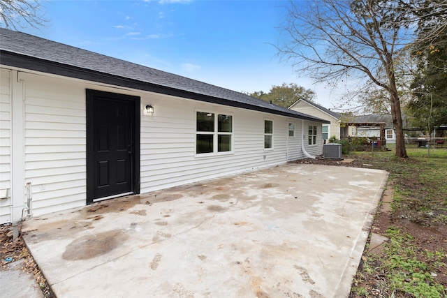 rear view of house featuring a patio area and central air condition unit