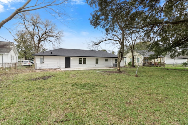 back of house with a lawn and a patio