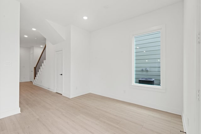 spare room featuring a healthy amount of sunlight and light hardwood / wood-style floors