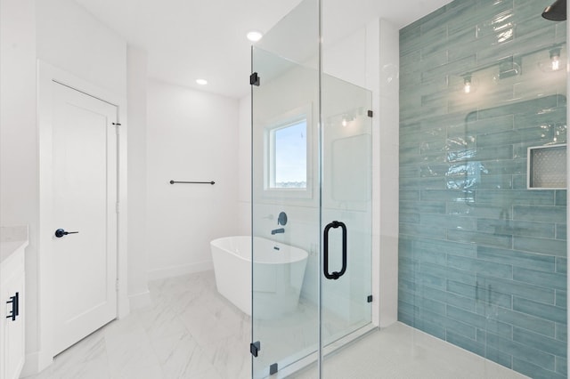 bathroom with vanity and independent shower and bath