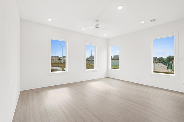 spare room with light wood-type flooring and ceiling fan