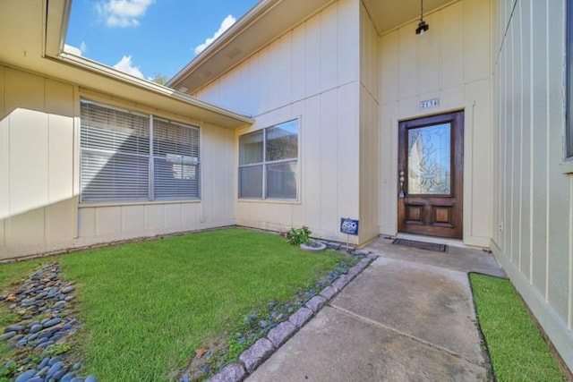 entrance to property with a yard