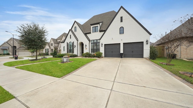 view of front of property with a garage and a front lawn