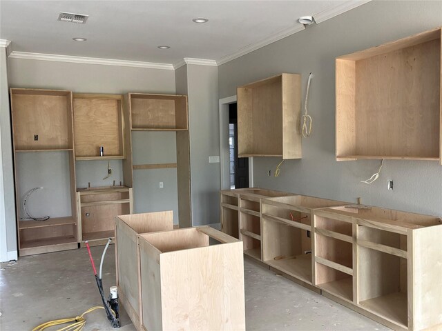 2419 Ryan St, Brenham, TX 77833 - kitchen featuring concrete flooring, ornamental molding, and a center island