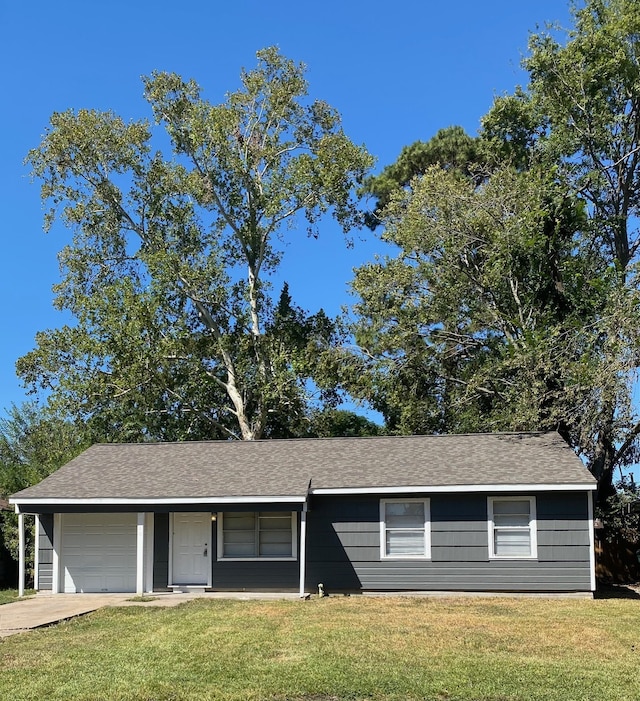 single story home with a garage and a front yard