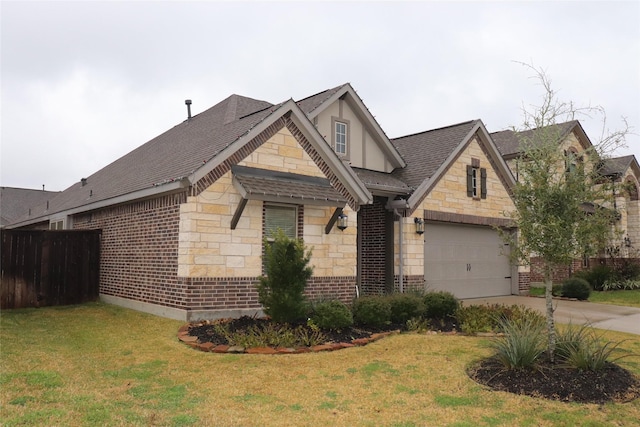 view of front of home with a garage and a front lawn