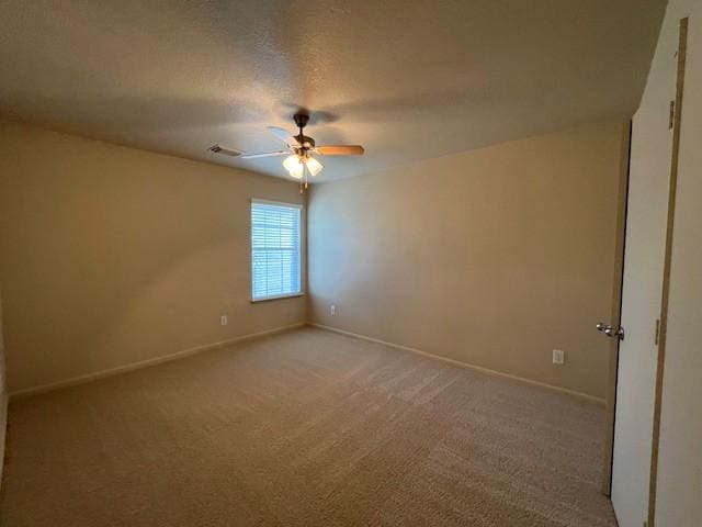 empty room featuring carpet floors and a textured ceiling