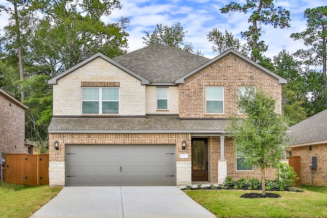 view of front of house featuring a front yard and a garage