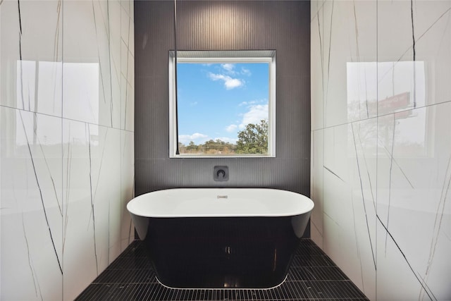 bathroom with tile patterned floors and a bathing tub