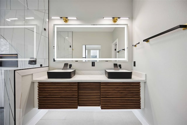 bathroom featuring tile patterned floors, vanity, and a shower