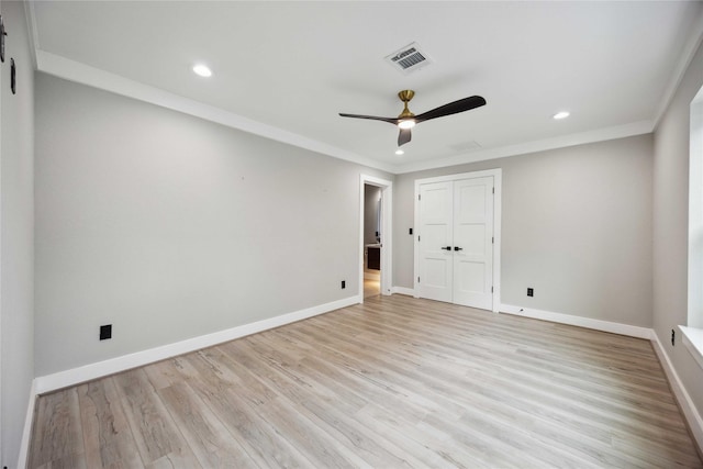 unfurnished bedroom featuring a closet, ceiling fan, crown molding, and light hardwood / wood-style flooring