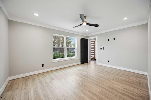 unfurnished room featuring light wood-type flooring, ceiling fan, and crown molding