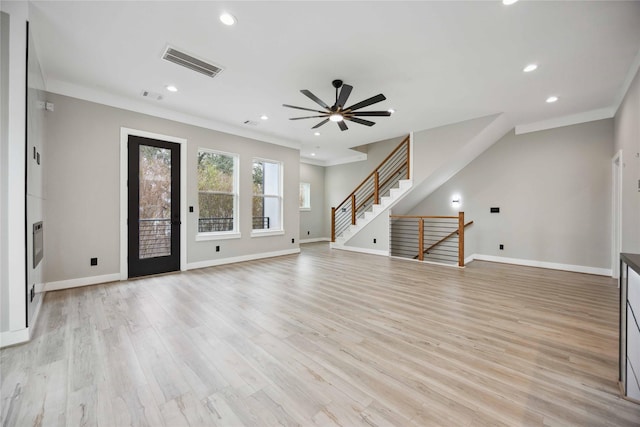 unfurnished living room featuring ceiling fan, light wood-type flooring, and ornamental molding