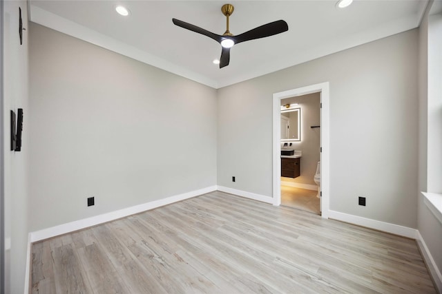 unfurnished bedroom featuring ceiling fan, light hardwood / wood-style floors, ornamental molding, and connected bathroom