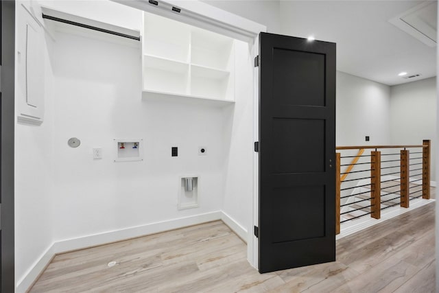 laundry room featuring hookup for an electric dryer, hookup for a washing machine, light hardwood / wood-style flooring, and gas dryer hookup