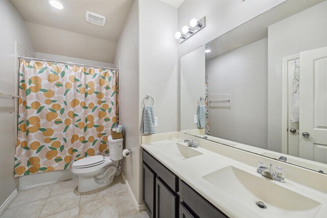 full bathroom with tile patterned floors, vanity, shower / tub combo, and toilet