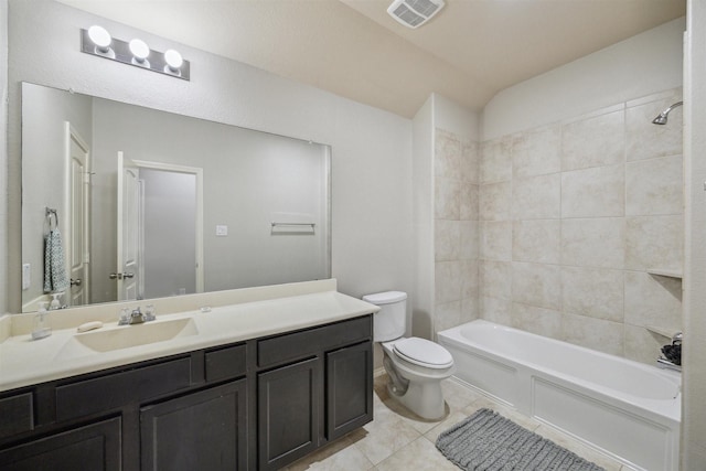 full bathroom with tile patterned flooring, tiled shower / bath combo, toilet, and vanity