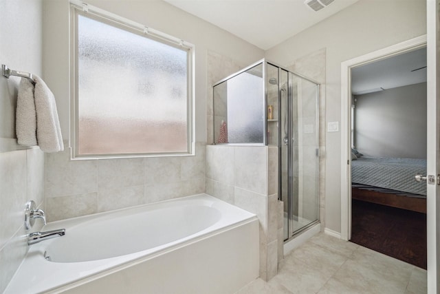 bathroom with shower with separate bathtub