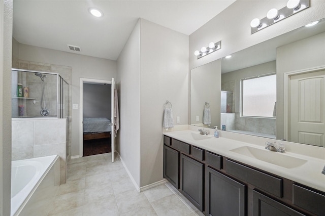 bathroom with vanity, tile patterned floors, and independent shower and bath