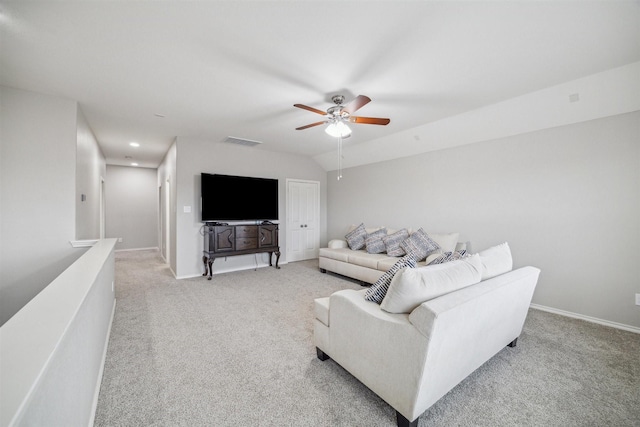 carpeted living room with ceiling fan and lofted ceiling