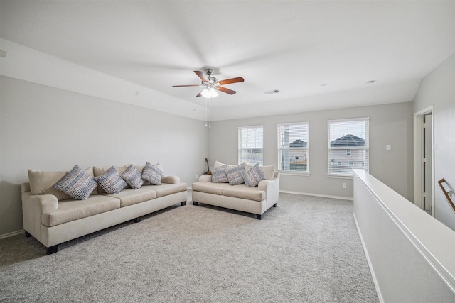 carpeted living room with ceiling fan