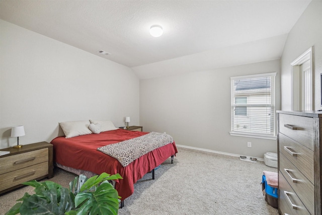 bedroom with light carpet and lofted ceiling