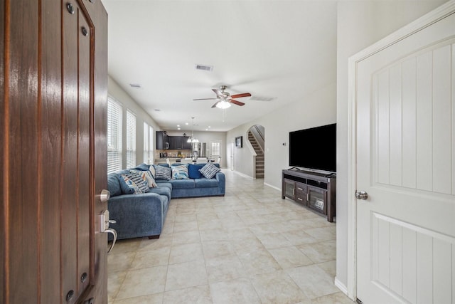 tiled living room featuring ceiling fan