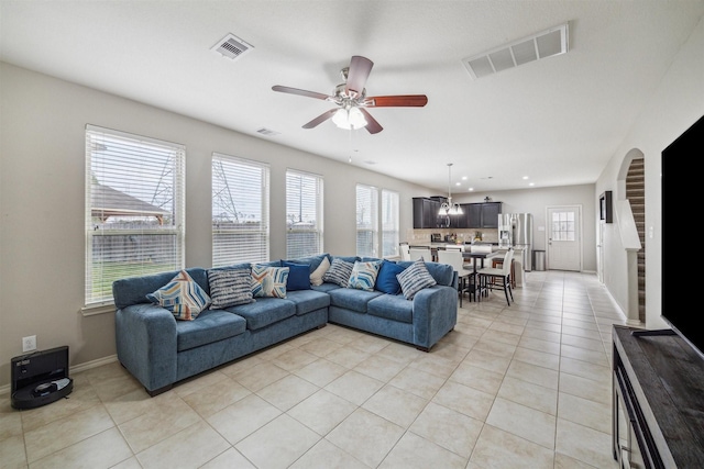 living room with ceiling fan and light tile patterned floors