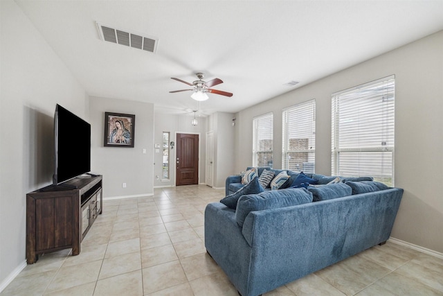 tiled living room featuring ceiling fan