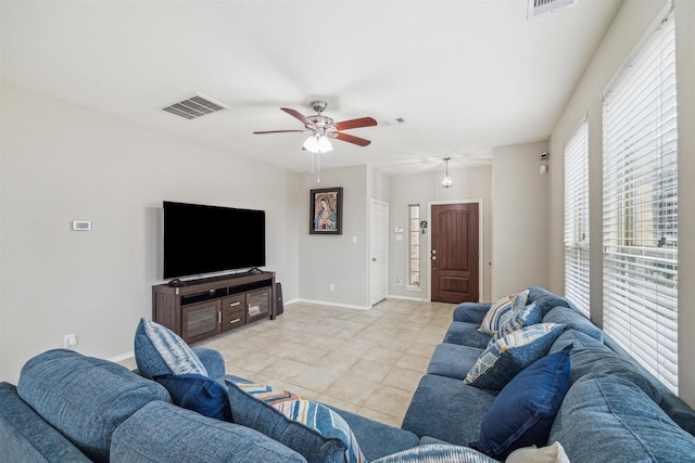 living room featuring ceiling fan and light tile patterned floors